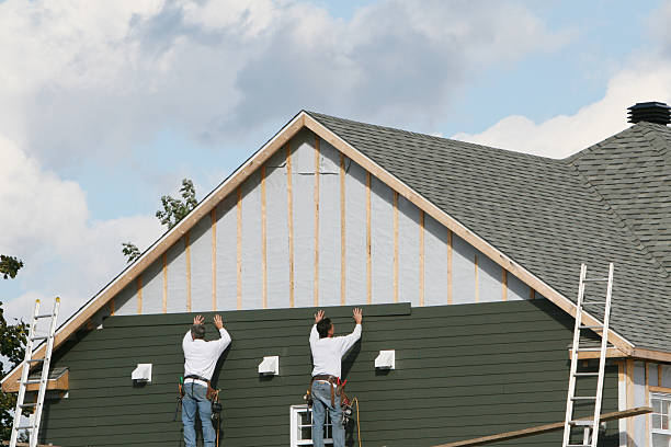 Professional Storm Damage Siding Repair technician working in New London, MN